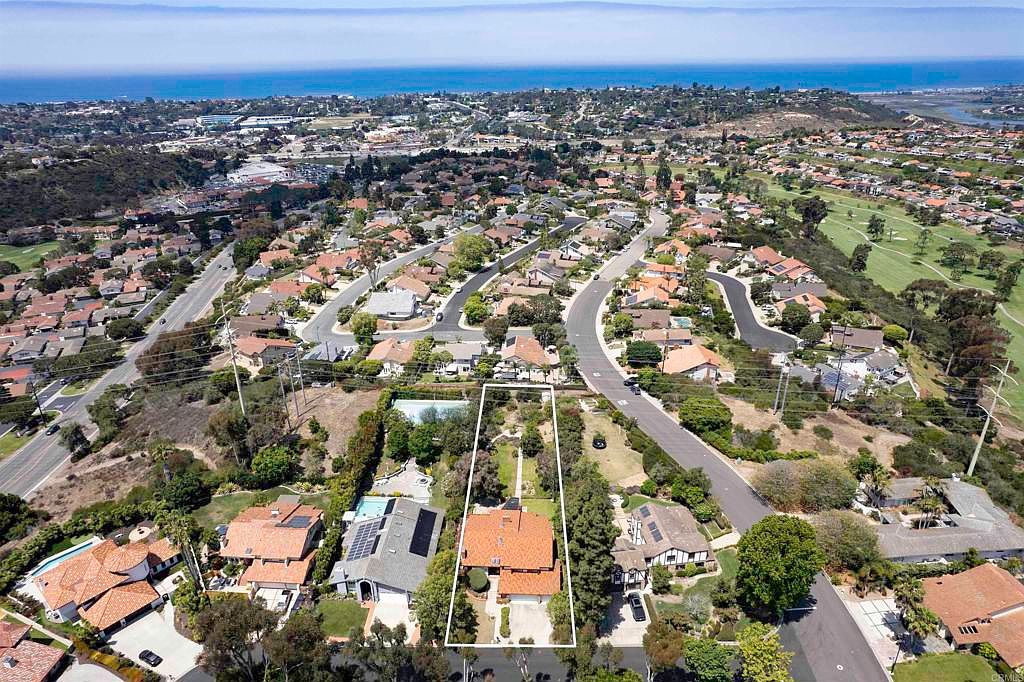 Aerial view of 245 Loma Corta Drive, a half-acre parcel in Loma Del Cielo, Solana Beach, with the Pacific Ocean visible on the horizon